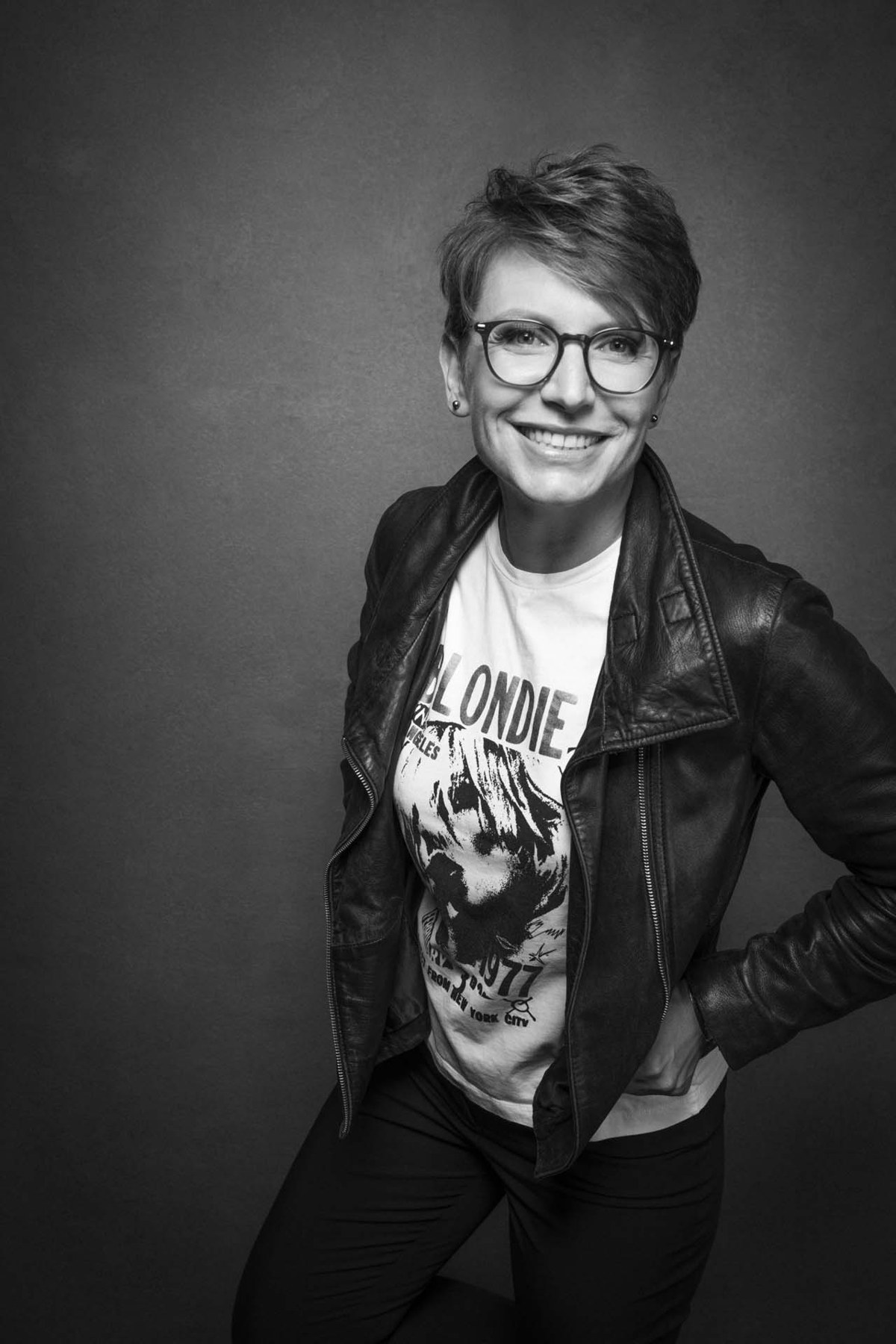 A woman smiling in her guided studio portrait
