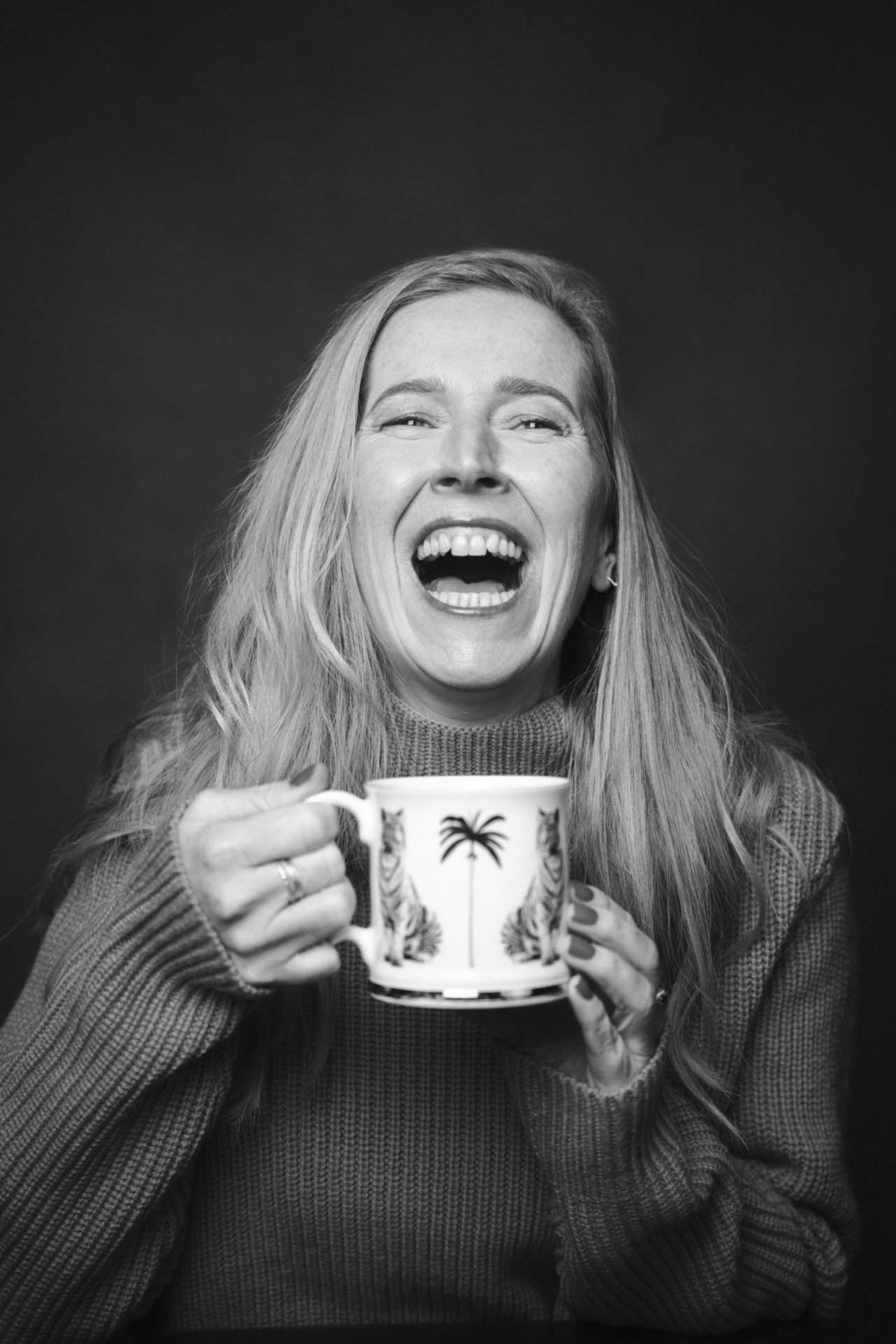 A woman laughing during her portrait session