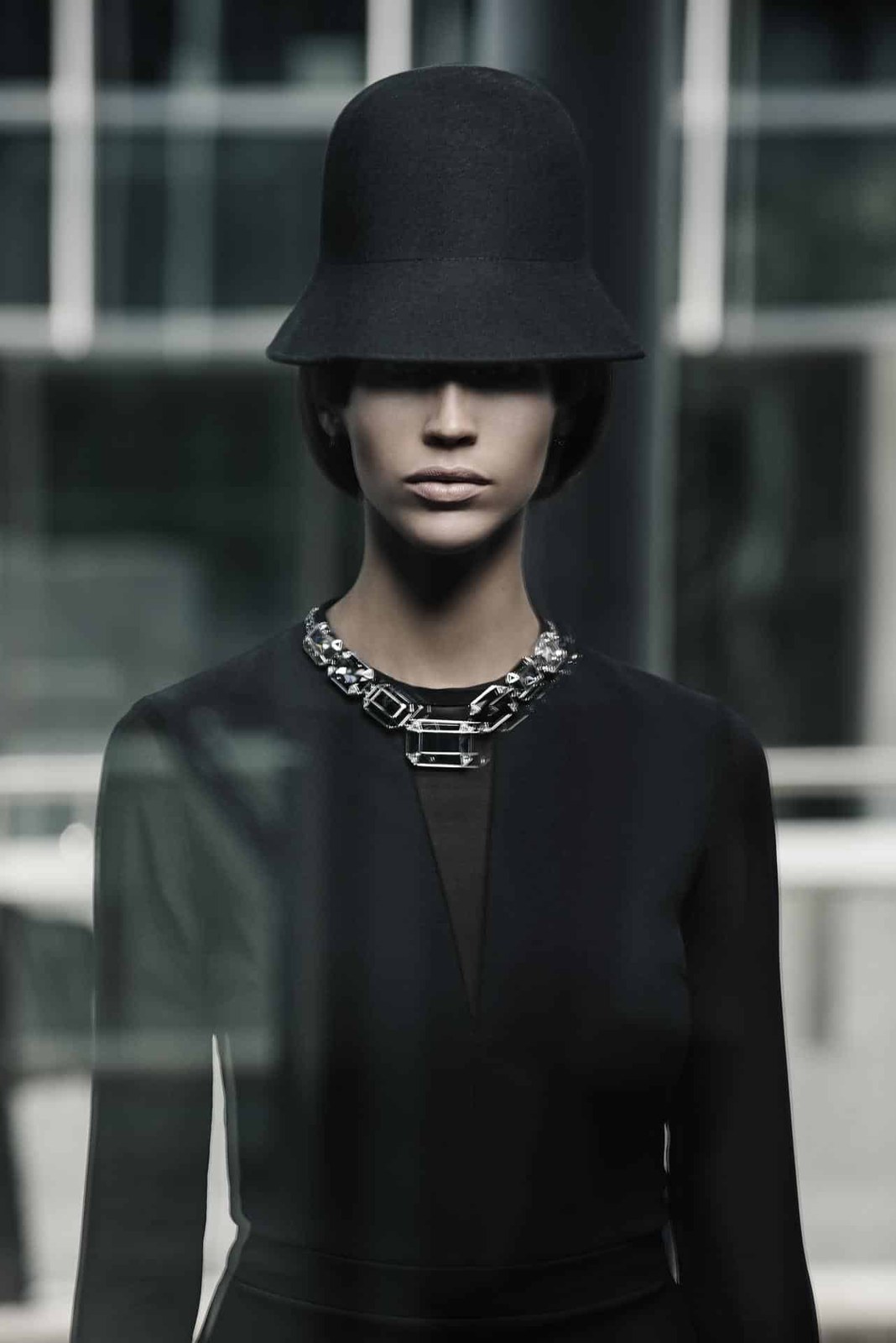 Fashion portrait of a woman in a structured hat, photographed by Oliver Doran
